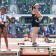 Gwendolyn Berry, left, third place, looks on during the playing of the national anthem with DeAnna Price, center, first place, and Brooke Andersen, second place, on the podium after the Women’s Hammer Throw final on day nine of the 2020 U.S. Olympic Track & Field Team Trials at Hayward Field on June 26, 2021 in Eugene, Oregon.